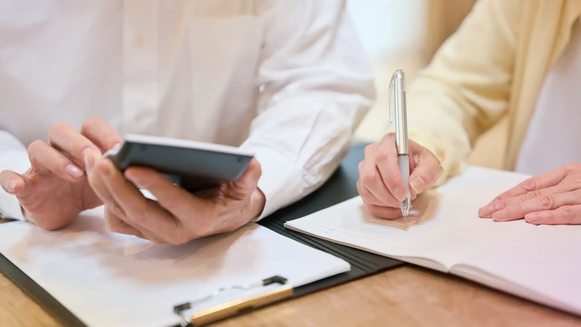 Connecticut homeowner reviewing insurance premium factors and rate calculations with insurance policy documents and financial advisor