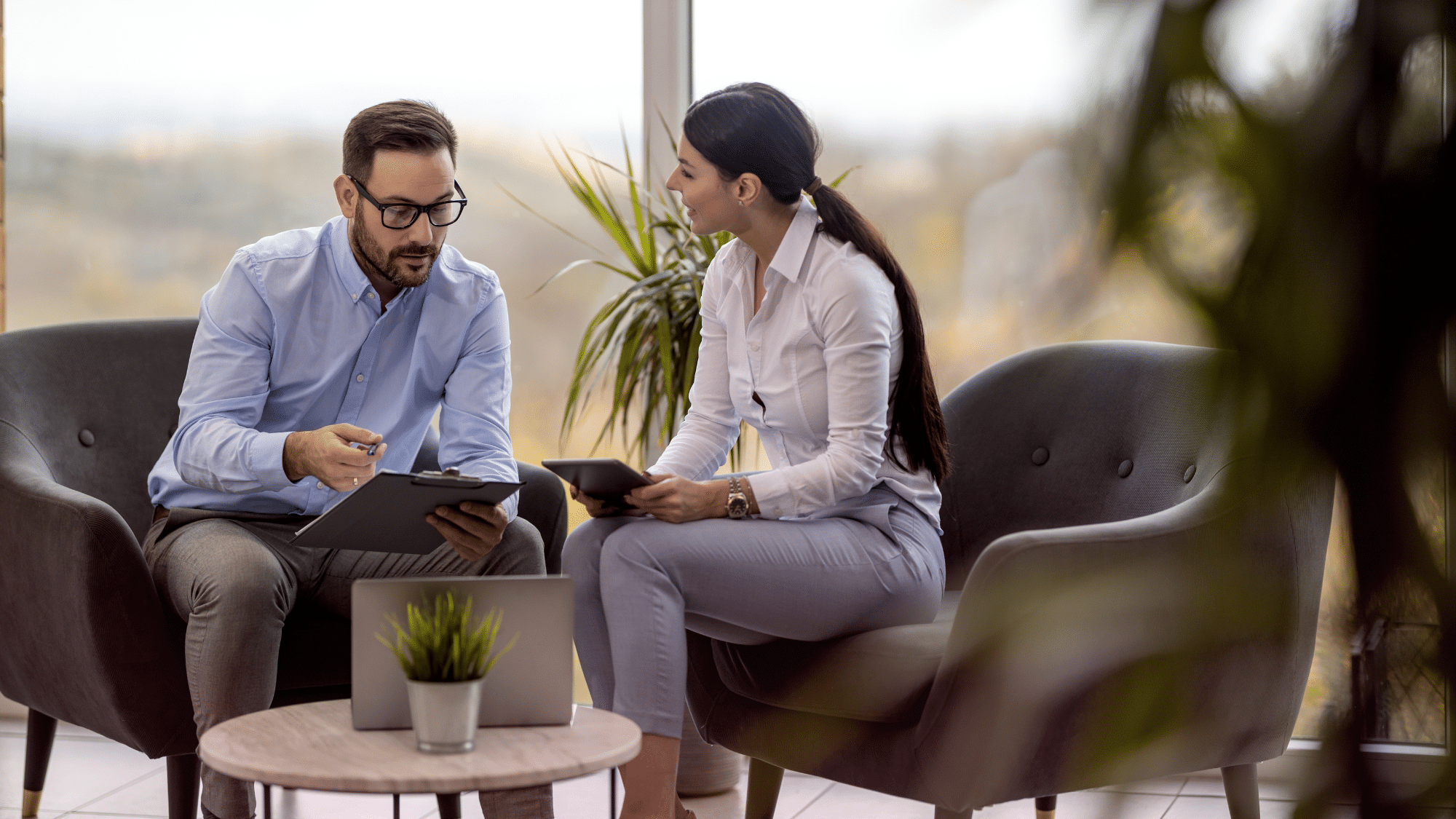 Insurance Agent Reviewing Coverage Options With A Client To Compare Insurance Policies And Help Select Appropriate Protection At A Competitive Value.